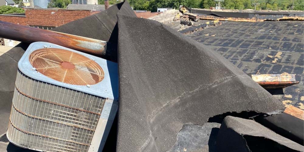 Flat Roof Membrane Ripped by Wind